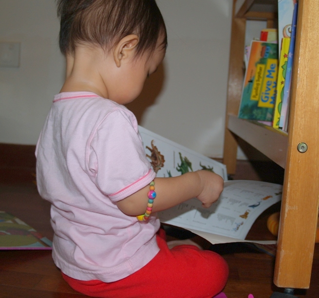 Zaria reading up stairs (check out the bracelet around her arm)
