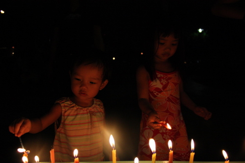 Girls lighting candles