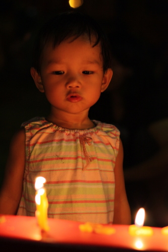 Zaria blowing off candles