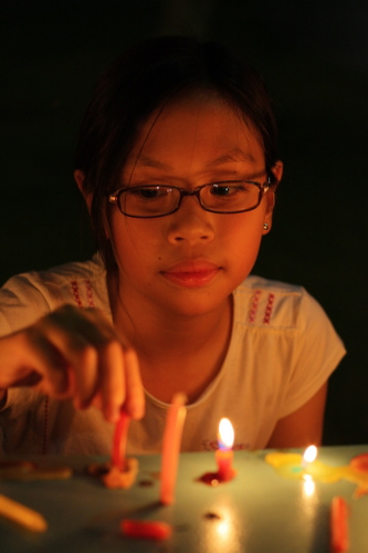 Sam lighting candles