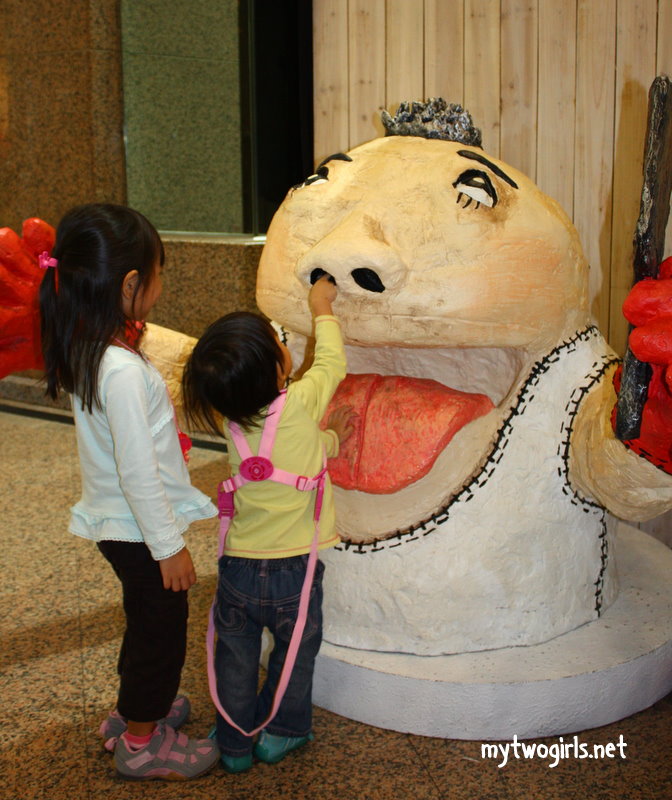Girls 'cleaning' nose of model