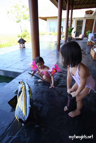 Zaria and Tasha trying to pump up a punctured motorcycle