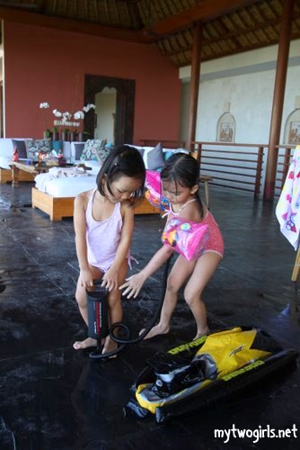 Zaria and Tasha trying to pump up a punctured motorcycle